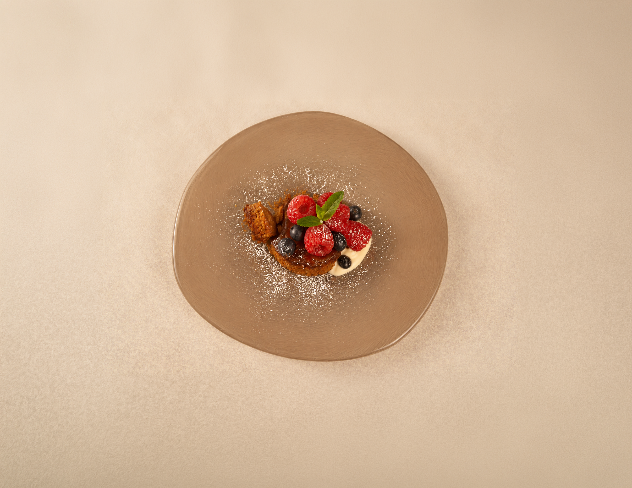 Overhead view of BAK caramel pudding with berries