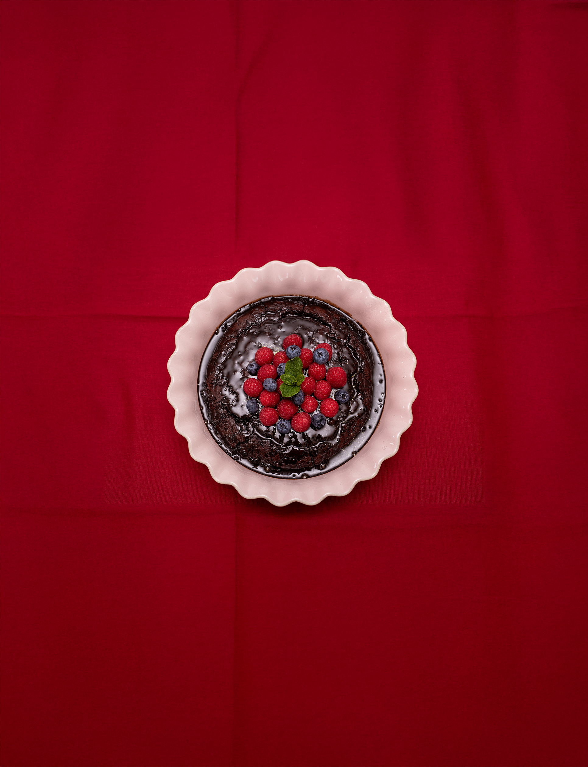 Chocolate pudding with berries viewed from above