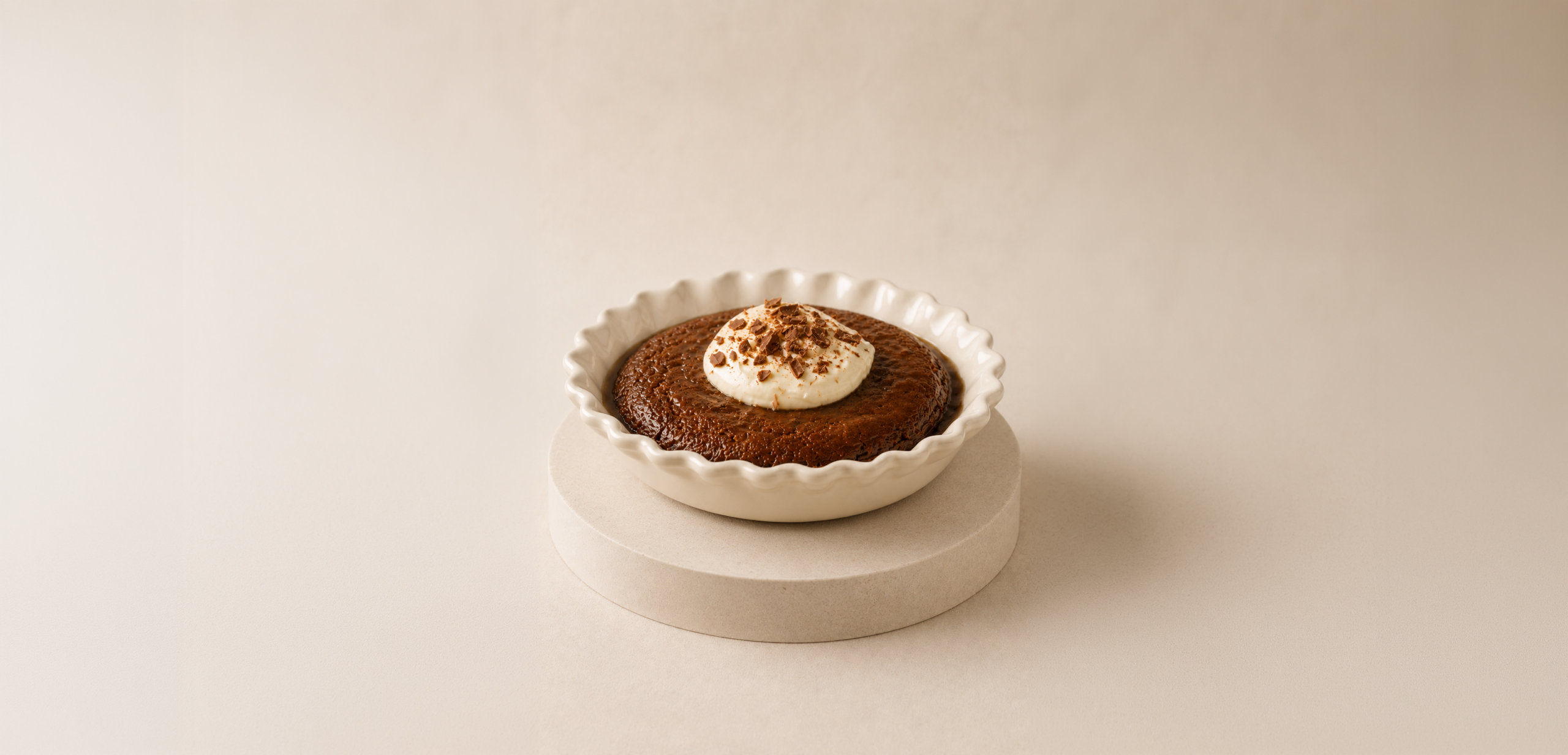 Salted caramel self-saucing pudding topped with cream and chocolate shavings